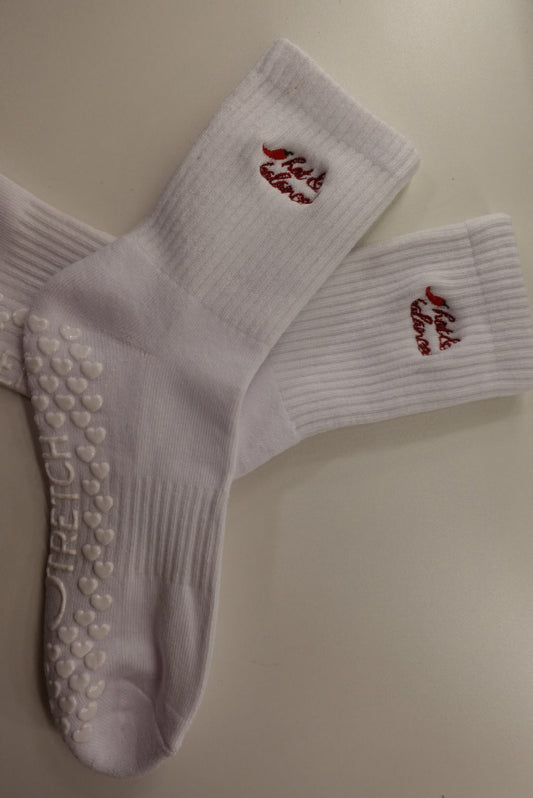 White socks with red text and sole patterns on a beige background